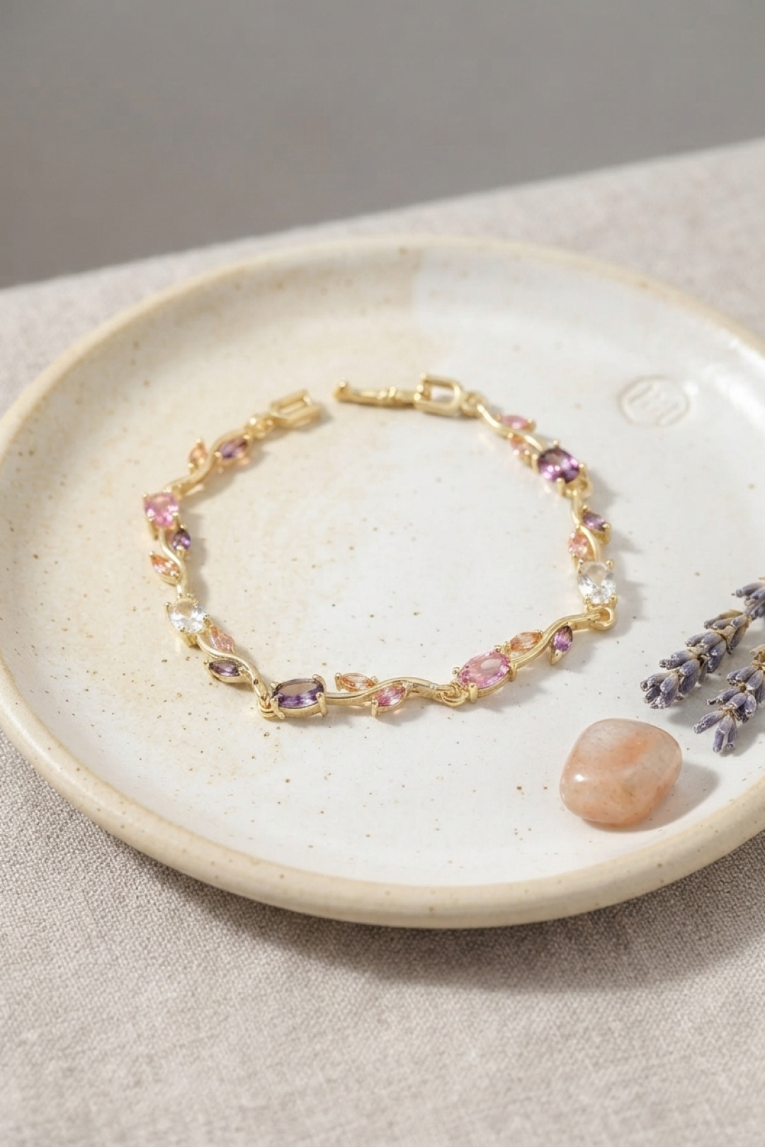 6a32ba56ab45ab06990c6fe9-8472c7b0-c4a2-4942-bc17-6b5afc37608a Pirinç Gold Renk Pembe ve Mor Zirkon Taşlı Çiçek Model Kadın Bileklik - Vipsepet - Görsel 1